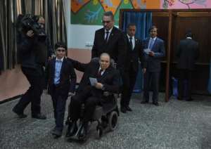 Algeria's ailing President Abdelaziz Bouteflika C, running for re-election, arrives to cast his ballot from a wheelchair at a polling station in Algiers on April 17, 2014.  By Farouk Batiche AFP