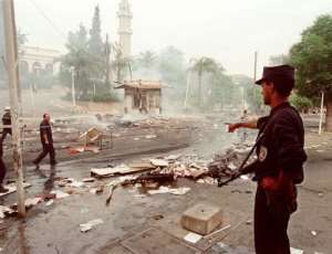 A policeman shows some of the damages from a protest on June 26, 1998 during the Algerian civil war, Algeria.  By  AFPFile