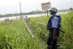 A military police officer stands in the Warri South district of Niger Delta, June 4, 2004.  By Pius Utomi Ekpei (AFP/File)