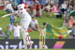 South African Captain and batsman Hashim Amla plays a shot for four runs during the first day of the first Test against the West Indies in Centurion on December 17, 2014.  By Gianluigi Guercia AFP