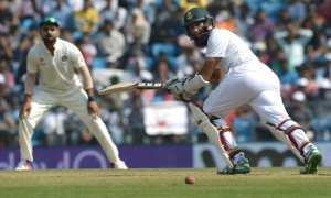 India's captain Virat Kohli L looks on as South Africa's captain Hashim Amla plays a shot on the third day of their third Test match, at The Vidarbha Cricket Association Stadium in Nagpur, on November 27, 2015.  By Indranil Mukherjee AFP