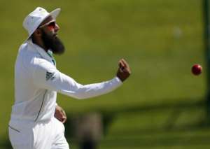 Hashim Amla of South Africa throws a cricket ball during the second day of th first Test against Pakistan at the Sheikh Zayed Cricket Stadium in Abu Dhabi on October 15, 2013.  By Karim Sahib AFPFile