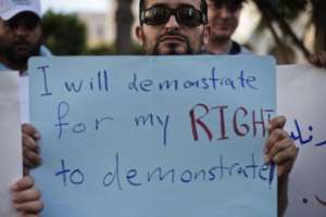 A Libyan man holds a sign during a protest  in Tripoli on September 28, 2012.  By Gianluigi Guercia AFPFile