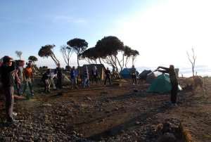 Participants on Kilimanjaro, aiming to play the world's highest game of cricket, practice at a high altitude campsite on September 21, 2014, the second day of a their eight-day trek.  By Peter Martell AFPFile