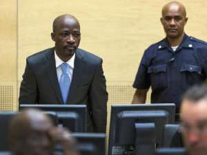 Ivorian ex-president's right-hand man Charles Ble Goude left looks on as he enters the courtroom of the International Criminal Court ICC for his initial appearance in The Hague, on March 27, 2014.  By Michael Kooren PoolAFPFile