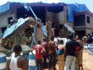 Bystanders look at the Sharon Church after it was struck by a suicide bomber in Kaduna on June 17.  By Victor Ulasi (AFP)
