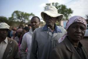 Residents queue to cast their ballots at a polling station in Serewe on October 24, 2014 in Botswana's general elections.  By Marco Longari AFP