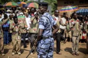 A policeman stands guard as representatives of Burundis ruling National Council for the Defence of Democracy - Forces for the Defence of Democracy party attend a rally in Rubiza on June 23, 2015.  By Marco Longari (AFP)