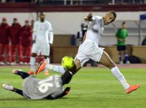 Algeria's Islam Slimani  R clashes with Malawi's goalkeeper during their 2015 Africa Cup of Nations qualifying match at the Mustapha Tchaker stadium on October 15, 2014 in Blida.  By  AFPFile