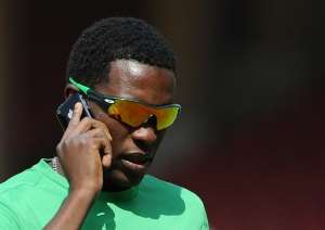 Zimbabwe cricket captain Elton Chigumbura speaks on his mobile phone on March 3, 2011.  By Punit Paranjpe AFPFile