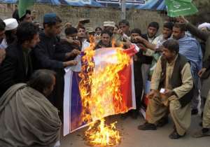 Pakistani demonstrators burn a French flag during a protest against the printing of satirical sketches of the Prophet Muhammad by French magazine Charlie Hebdo in Quetta on January 16, 2015.  By Banaras Khan AFP