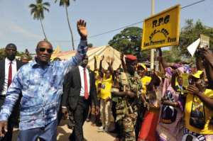 President Alpha Conde of Guinea waves at supporters on October 8, 2015 during a presidential election campaign in Conakry.  By Cellou Binani AFP