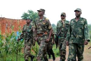 Colonel Mamadou Ndala (2nd L), pictured as he patrolls with his troops in Kokola, near Eringeti, Democratic Republic of the Congo, on December 31, 2013. By Alain Wandimoyi (AFP/File)