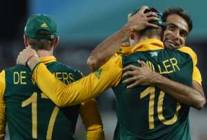 Imran Tahir right hugs David Miller after he catches Dwayne Smith off his bowling during the World Cup match between South Africa and the West Indies at the Sydney Cricket Ground on February 27, 2015.  By Peter Parks AFP