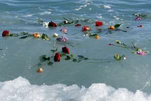 Flowers float into the Mediterranean sea on April 28, 2015 in Nice, France, in honor of migrants who drowned trying to reach Europe.  By Valery Hache AFPFile
