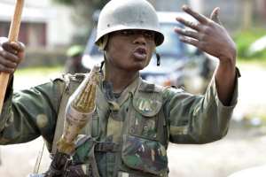 A FARDC governmental soldiers gestures as he patrol on November 1, 2013 in the city of Bunagana, near the border with Uganda.  By Junior D. Kannah AFP