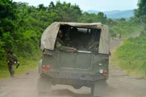 DR Congo army soldiers patrol on a road near Kimbumba, on October 31, 2013.  By Junior D. Kannah AFPFile