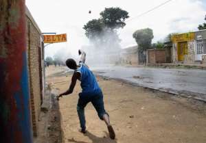 A protester throws stones at police during street battles in Bujumbura on May 4, 2015.  By Aymeric Vincenot AFPFile