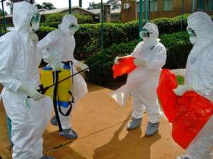 Officials from the World Health Organization wear protective gear as they prepare to enter Kagadi Hospital.  By Isaac Kasamani AFPFile