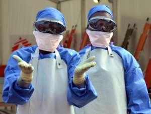 Liberian health workers at the NGO Medecins Sans Frontieres Doctors Without Borders Ebola treatment center in Monrovia, on October 18, 2014.  By Zoom Dosso AFP