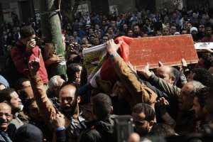 Mourners carry a coffin during the funeral of activists Amro Saad and Mohammed al-Guindi in Cairo on February 4, 2013.  By Gianluigi Guercia AFP