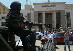 Egyptian police secure the area outside a courthouse in the Cairo district of Heliopolis on June 25, 2014.  By Khaled Desouki AFPFile