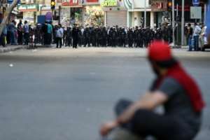 A protester sits in front of riot policemen during a demonstration on April 15, 2016 outside the Journalists' Syndicate in central Cairo against a controversial deal to hand two islands in the Red Sea to Saudi Arabia.  By Mohamed El-Shahed AFPFile