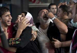 Palestinian mourners cry at Gaza City's al-Shifa hospital after an explosion killed at least seven children in a public playground in the beachfront Shati refugee camp on July 28, 2014.  By Mahmud Hams AFP