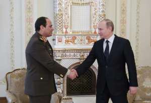 Egyptian army chief Abdel Fattah al-Sisi L shakes hands with Russian President Vladimir Putin during their meeting in the latter's Novo-Ogaryovo residence, outside Moscow, on February 13, 2014.  By Mikhail Metzel RIA-NOVOSTIAFP