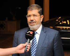 Former Egyptian President Mohamed Morsi speaks to Egyptian Television ahead of an emergency meeting at the presidential palace in Cairo on August 5, 2012.  By Egyptian Presidency Egyptian PresidencyAFPFile