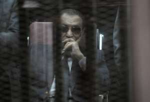 Ousted Egyptian president Hosni Mubarak sits in the defendants cage during his verdict hearing in a retrial for embezzlement on May 9, 2015 in the capital Cairo.  By - AFPFile