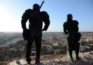 Algerian security forces stand guard on a ridge looking down on the city of Ghardaia on March 18, 2014.  By Farouk Batiche AFPFile