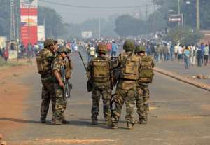 French troops of the Sangaris Operation stand guard as anti-Seleka protesters demonstrate calling for the resignation of the Central African Republic president in Bangui on January 10, 2014.  By Eric Feferberg AFP