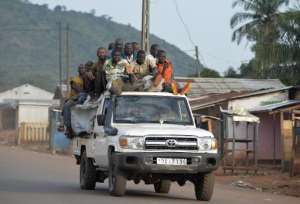 Members of the ex-Seleka rebels drive near a convoy of Chadian soldiers Unseen leaving Bangui escorted by the African-led International Support Mission to the Central African Republic MISCA on April 4, 2014.  By Miguel Medina AFPFile