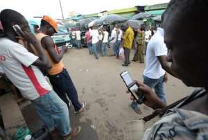 File picture shows people using their mobile phones at the Adjame market in Ivory Coast's capital Abidjan on June 23, 2009.  By Issouf Sanogo AFPFile