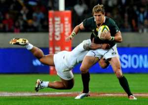 South Africa's Wynand Olivier C is tackled by an England player.  By Alexander Joe AFP