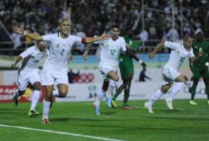 Madjid Bougherra left celebrates after scoring a goal against Burkina Faso during their World Cup qualifier in Blida, Algeria on November 19, 2013.  By Farouk Batiche AFP