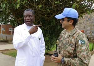 Congolese surgeon and gynaecologist Dr. Denis Mukege L chats with a Pakistani MONUSCO soldier tasked with his protection at Panzi Hospital in the outskirts of Bukavu, eastern DR Congo, on March 18, 2015.  By Marc Jourdier AFPFile