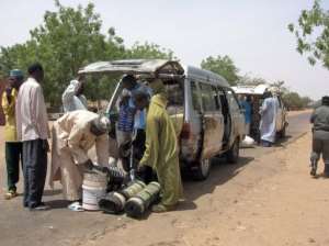 Vehicles coming from Nigeria are checked at the Tinkim border checkpoint.  By Natasha Burley (AFP/File)