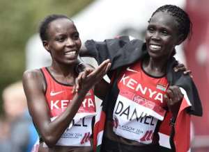 Kenya's Flomena Daniel right celebrates with team-mate and silver medalist Croline Kilel after winning the Commonwealth Games women's marathon in Glasgow on July 27, 2014.  By Andrej Isakovic AFP
