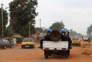 Soldiers with the UN's MINUSCA mission ride on a vehicle on September 15, 2014 in Bangui.  By Pacome Pabandji AFPFile
