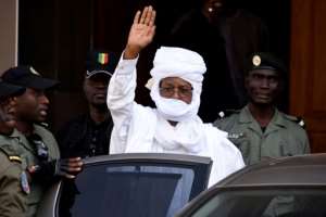 Former Chadian dictator Hissene Habre gesturing as he leaves a Dakar courthouse after an identity hearing on June 3, 2015.  By SEYLLOU AFPFile