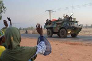 Locals wave to French soldiers as a convoy leaves Bamako headed to the north of Mali on January 15, 2013.  By Eric Feferberg AFP