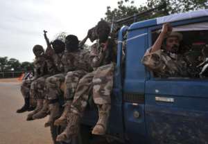 Malian soldiers enter Ansongo, January 29, 2013, a town south of the northern Malian city of Gao.  By Kambou Sia AFP