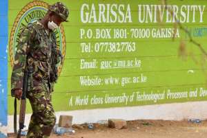 A Kenyan soldier walks past the entrance of Moi University in Garissa on April 3, 2015, a day after the massacre of 148 people by Somalia's Shebab fighters.  By Carl de Souza AFPFile