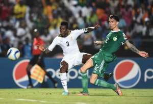 Ghana forward Asamoah Gyan L scores a goal past Algeria defender Carl Medjani during the 2015 Africa Cup of Nations group C match in Mongomo, Equatorial Guinea on January 23, 2015.  By Carl De Souza AFP