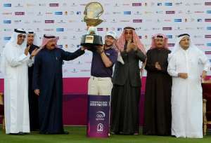 South Africa's Branden Grace C poses with the winners trophy after the final round of the Qatar Masters golf competition at the Doha Golf Club on January 24, 2015.  By  AFP