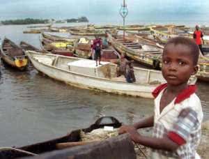 Children play on fishing boats in the harbour at Conakry, Guinea, on August 10, 1999.  By Issouf Sanogo AFPFile