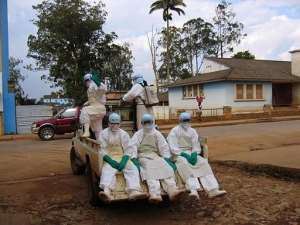 This picture taken on April 9, 2005 shows five health workers, dressed in head-to-toe Ebola suits, in Uige, Angola.  By Florence Panoussian AFPFile