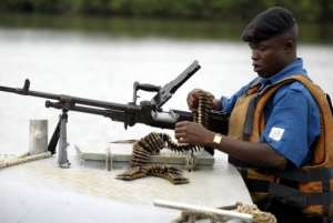 A naval officer assembles his machine gun before starting a patrol of the Niger Delta region in 2004.  By Pius Utomi Ekpei (AFP/File)